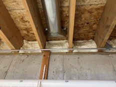 Spray foam installed along the rim joist of a home